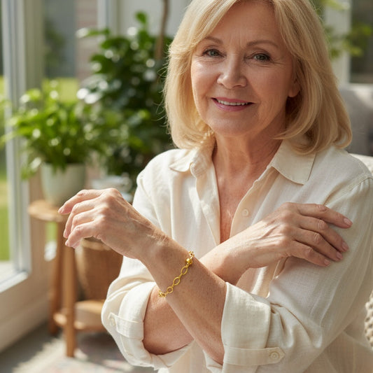 Woman in a white shirt sitting indoors with plants in the background